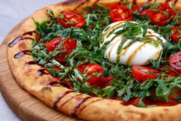 Burrata Arugula Pizza with Cherry Tomatoes Pesto and Balsamic Drizzle Artisan pizza topped with creamy burrata, fresh arugula, cherry tomatoes, pesto and balsamic drizzle. (License=RF) Copyright: xZoonar.com AntonxVasiljevx 23496671