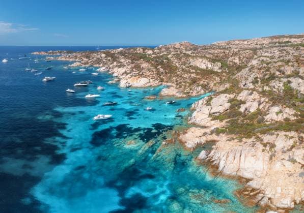 Breathtaking aerial view capturing luxury yachts moored along the rocky coastline of la maddalena archipelago in sardinia, revealing vibrant turquoise waters and pristine beauty Breathtaking aerial view capturing luxury yachts moored along the rocky coastline of la maddalena archipelago in sardinia island, revealing vibrant turquoise waters. Top view of boats and blue sea Model Released DenisBilytskyi_ID28944_860362_027 Copyright: xx
