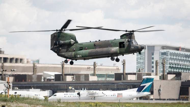 June 15, 2025, Calgary, Ab, CANADA: A Canadian Armed Forces Chinook helicopter hovers as a WestJet airplane passes by while dignitaries arrive in Calgary, Alta., Sunday, June 15, 2025, to attend the G7 Leaders meeting taking place in the nearby community of Kananaskis. Calgary CANADA  - ZUMAc35_ 20250615_zaf_c35_091 Copyright: xJeffxMcintoshx