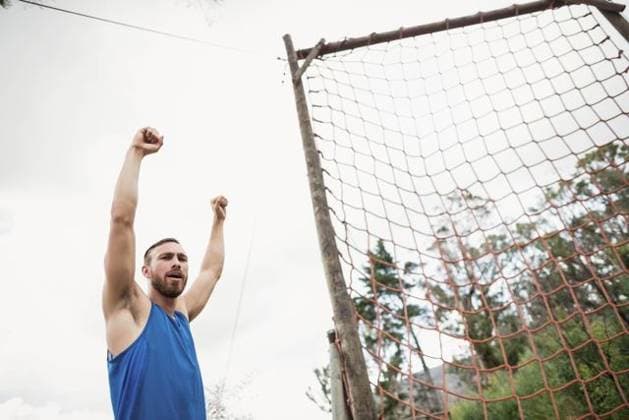 Creative Highlights Symbolbilder Man raising both arms overhead beside rope net obstacle at wooded clearing with wooden poles Man raising both arms overhead beside rope net obstacle at wooded clearing with wooden poles. Adventure, fitness, challenge, outdoor, activity, resilience, landscape, model released, , property released, , 24.11.2016, 6783708.jpg, rope net obstacle,man,raising arms,outdoor,fitness,challenge,adventure,resilience,wooded clearing,wooden poles,landscape,adult,white male,athletic,blue sleeveless shirt,shorts,trimmed beard,short hair,cheering,shouting,grid ropes,orange ropes,weathered,treetops,overcast sky,grass,mixed trees,evergreen,deciduous,single person,active,exercise,outdoors,nature,casual,healthy,strength,standing,body movement,fitness challenge,i