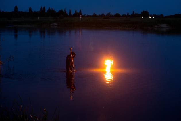 June 21, 2025, Cigacice, Lubusz Voivodeship, Poland: A man in black robe is standing in the Odra River during the Kupala Night celebrations. Kupala Night (Polish: Noc KupaÂ³y) is an old Slavic holiday celebrated on the night of the summer solstice. It combines the cult of nature, fertility, fire and water. Cigacice Poland - ZUMAs197 20250621_aaa_s197_469 Copyright: xKarolxSerewisx