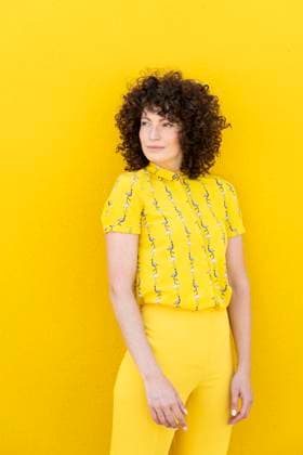 Creative Highlights Symbolbilder Beautiful woman standing in front of yellow wall model released, Symbolfoto, LMCF01274