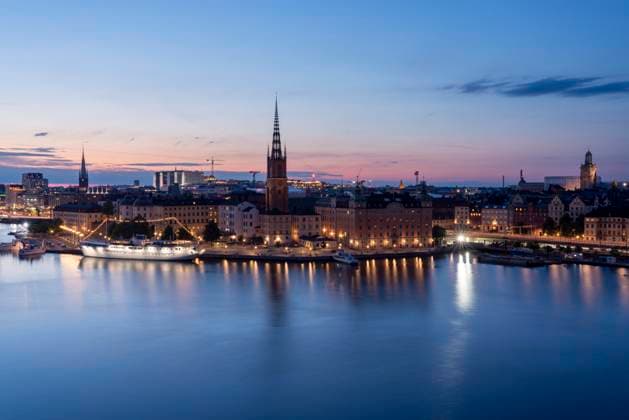 Scenic view of Stockholm s Riddarholmen and Gamla Stan at sunset with reflections on Lake Malaren., TAMF04809