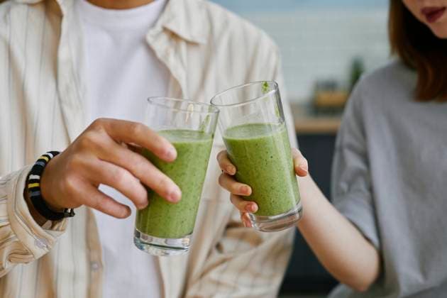 Two people toasting with green smoothies indoors model released, Symbolfoto property released, KPEF01083