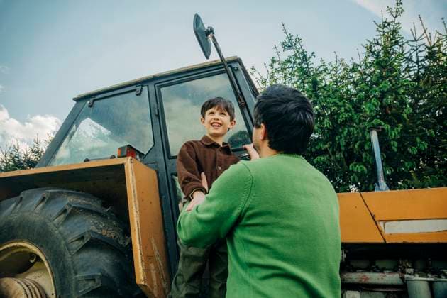 Creative Highlights Symbolbilder Father and son enjoying time together on a farm with an old tractor model released, Symbolfoto property released, VSNF03403