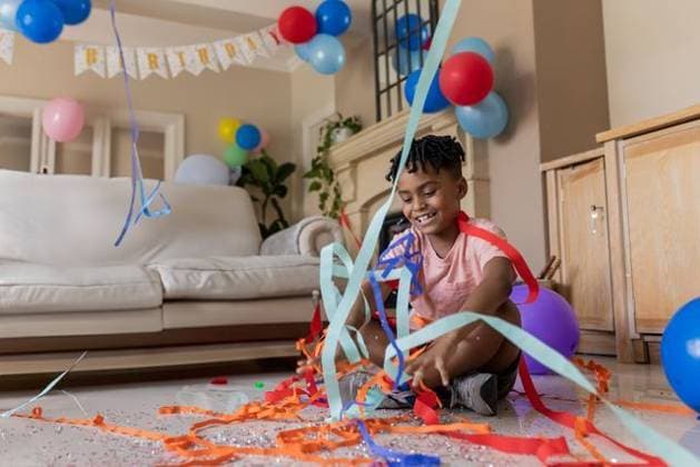 Creative Highlights Symbolbilder African American boy sitting on floor tossing streamers and balloons in living room, copy space African American boy sitting on floor tossing streamers and balloons in living room, copy space. Festivities, celebration, joy, childhood, playful, colorful, domestic, model released, , property released, , 22.11.2024, 6183321.jpg, people,birthday,boy,african american,living room,balloons,streamers,celebration,joy,childhood,playful,copy space,colorful,domestic,hardwood floor,party,confetti,banner,couch,fireplace,plants,cabinet,sneakers,t-shirt,shorts,smiling,decorations,festive,home,happy,cozy,potted plants,wooden,furniture,floating balloons,red balloons,blue balloons,sitting,playful moment,cheerful,vibrant,child,solo,one person,casual clothing,