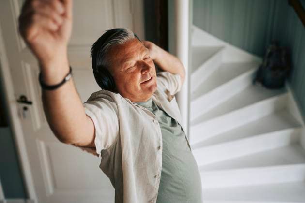 Creative Highlights Symbolbilder High angle view of senior man grooving on music by wearing wireless headphones at home Sweden, Gothenburg, model released, property released Copyright: xMaskotx , MA118024 MA118024