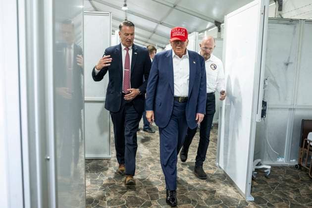 July 1, 2025, Ochopee, Fl, United States of America: U.S. President Donald Trump, right, listens to Acting Director of ICE Todd Lyons, left, during a facility tour at Dade-Collier Training and Transition Airport, July 1, 2025 in Ochopee, Florida. Trump plans on building a massive immigration detention center on the site named Ã¢â‚¬oeAlligator Alcatraz. Ochopee United States of America - ZUMAp138 20250701_zaa_p138_029 Copyright: xDanielxTorok WhitexHousex