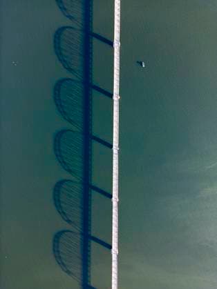 MR_ID29252_21359_MarielaWaczinsky.jpg, PR_ID29252_11342_MarielaTattos.jpg A stunning aerial view captures Bethanga Bridge spanning Hume Lake, near the Hume Dam in Australia. The bridge s shadow elegantly reflects on the tranquil water below, Property released Model Released JuanAizpuru_ID29252_934937_002 Copyright: xJuanxAizpurux