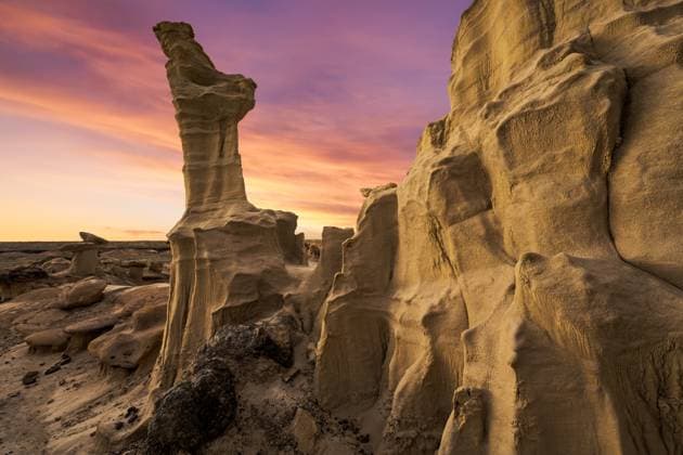 Stunning rock formations under a vibrant sunset in the Bisti De-Na-Zin Wilderness, New Mexico. The badlands of this desert region create an otherworldly landscape. Model Released JuanLopez_ID29356_975611_001 Copyright: xJuanxLopezx