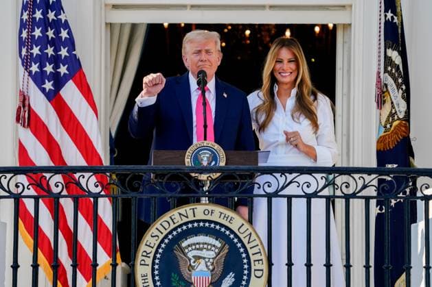 US President Donald Trump, left, and First Lady Melania Trump during a signing ceremony for the One Big Beautiful Bill Act on the South Lawn of the White House in Washington, DC, US, on Friday, July 4, 2025. Trump signed his $3.4 trillion budget bill into law Friday, enshrining an extension of tax cuts, temporary new breaks for tipped workers and funding to crack down on illegal immigration.  WAX20250704107 KENTxNISHIMURA