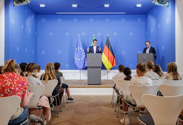 05.07.2025. Düsseldorf. Was macht eine Staatskanzlei? Wie funktioniert Demokratie? Wie arbeitet ein Ministerpräsident? Fragen wie diese – und viele weitere – stellen Schülerinnen und Schüler aus zwei Grundschulen (GGS Engelskirchen-Ründeroth und GGS Marktschule Bonn-Pützchen) Nordrhein-Westfalens Ministerpräsident Hendrik Wüst während einer Kinderpressekonferenz im Rahmen des Tags der offenen Tür im Regierungsviertel. Hier: Christian Wiermer, Regierungssprecher des Landes Nordrhein-Westfalen und Staatssekretär für Europaangelegenheiten sowie Internationales. Düsseldorf Staatskanzlei Nordrhein-Westfalen Deutschland *** 05 07 2025 Düsseldorf What does a state chancellery do How does democracy work How does a minister president work Pupils