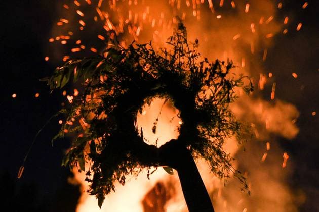 RUSSIA, MOSCOW REGION - JULY 5, 2025: A flower crown is seen in front of a bonfire during festivities marking Ivan Kupala Day, a pagan summer solstice celebration, at the Vasilkovoye Ozero holiday park. Valeria Kalugina TASS  82256444