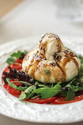 Portion Burrata-Salat mit Tomaten und Rucola Portion of gourmet burrata salad with tomatoes and arugula (License=RF) Copyright: xZoonar.com MaximxSparishx 23730860