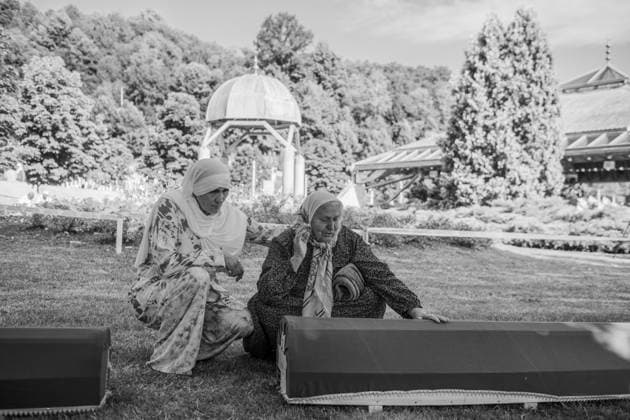 July 11, 2025, Potocari, Bosnia and Herzegovina: Two women are praying and crying desperately in front of a coffin, crouched. In this place every year, on the 10th and 11th of july, the commemoration for the people who got killed takes place, with prayers and ceremonies. In 1995, during the Bosnian War, the city was the site of the killing of more than 8.000 Bosniak men and boys, perpetrated by the units of the Bosnian serb army of Republika Srpska, led by Ratko MladiÄ‡, because they were muslim. This happened in a zone defined safe by United Nation (UN). On July 11, 2025, the International Day of Reflection and Commemoration of the 1995 Genocide in Srebrenica takes place.. Sad people are passing by. In this place every year, on the 10th an - ZUMA 20250711_mda_b283_304 Copyright: xSebastianoxBaccix