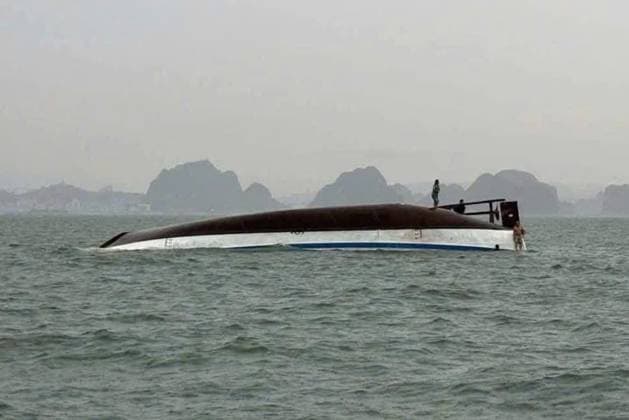 Bilder des Jahres 2025, News 07 Juli 18 dead, many missing after Vietnamese tourist boat capsizes HALONG BAY, QUANG NINH PROVINCE, VIETNAM - JULY 19: (----EDITORIAL USE ONLY - MANDATORY CREDIT - VIETNAMS S TRAFFIC POLICE DEPARTMENT HANDOUT - NO MARKETING NO ADVERTISING CAMPAIGNS - DISTRIBUTED AS A SERVICE TO CLIENTS----) Two men are seen standing on a capsized tourist boat, which was believed to be carrying more than 50 passengers on board, in Halong Bay, Quang Ninh Province, Vietnam, on July 19, 2025. At least 18 people have died and 23 are missing after a tourist cruise boat carrying 53 people capsized in Vietnam s Ha Long Bay on Saturday, according to officials. Vietnam s Traffic Police Department Handout Anadolu Quang Ninh Province Vietnam. Editorial use only. Plea  Copyright: x2025xAnadoluxVietnam sxTrafficxPolicexDepartmentx xHandoutx
