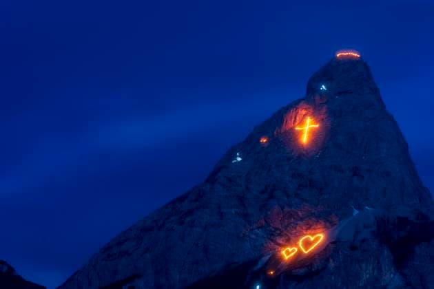 Bergfeuer Ehrwald (Mountain Fires), view to mountain Ehrwalder Sonnenspitze: Every year on the weekend around St. John s Day (summer solstice, June 21), the imposing mountain scenery surrounding the Ehrwald-Lermoos-Biberwier valley basin is transformed into a unique experience during the traditional solstice fires, with the laying out of large figures made from thousands of incendiary devices. The figures range from Christian symbolism and motifs from the flora and fauna to depictions of complex images. Additional laying out of chains of fire along the mountain ridges. Ehrwald Tiroler Zugspitz Arena Tirol, Tyrol Austria