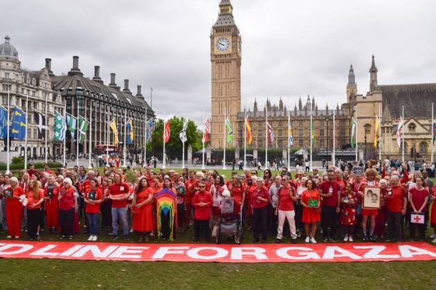 July 22, 2025, London, England, United Kingdom: Protesters stand in Parliament Square with various objects as campaigners from various charities and NGOs stage a protest against ongoing attacks on Palestine by Israel. The campaigners say that this is the final demonstration in their Red Line For Gaza series of protests. London United Kingdom - ZUMAv130 20250722_zip_v130_016 Copyright: xVukxValcicx