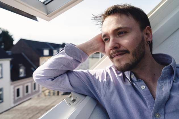 Creative Highlight Symbolbilder Student relaxing in first home attic by window with city view model released, Symbolfoto property released, KNSF11463