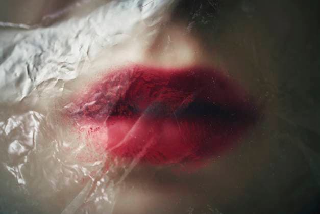 Creative Highlight Symbolbilder Red lips with lipstick under plastic foil symbolizing asphyxiation and beauty model released, Symbolfoto, AZF00673