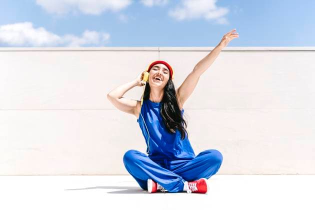 Creative Highlight Symbolbilder Happy woman in blue outfit with red accessories dancing outdoors model released, Symbolfoto, JCZF01703