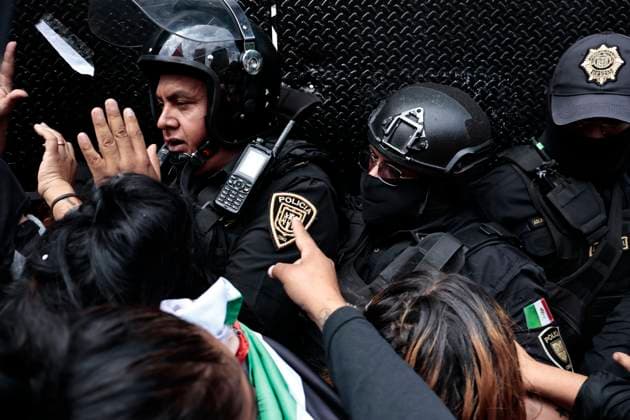 July 26, 2025, Mexico, Cdmx, Mexico: In light of the ongoing and apparently increasing gentrification in Mexico City, a small group of protesters gathered to march from the Hemiciclo a Juarez (Juarez City Hall) to the U.S. Embassy. Moments before the march began, they reversed course toward the city s Zocalo. Hundreds of police officers were deployed by the Ministry of Citizen Security to contain any attacks or damage caused by members of the Black Bloc. Mexico Mexico - ZUMAp204 20250726_zip_p204_009 Copyright: xJosuexPerezx