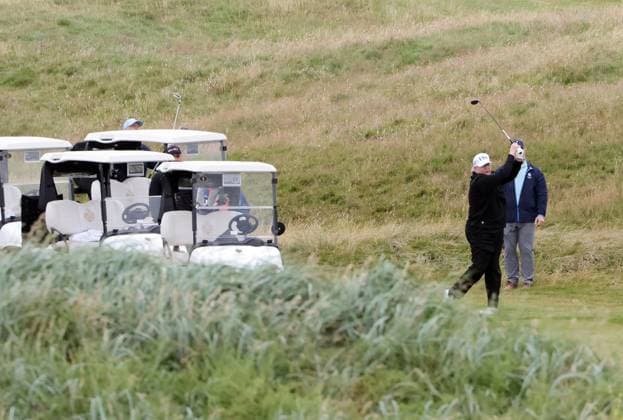 American President Donald Trump waves to the media whilst playing golf at Turnberry Golf Club, Ayrshire in Scotland on Sunday, July 27, 2025. Trump is on a four day visit to Scotland where he will be playing golf and meeting International leaders for trade discussions.  LON2025072709 HUGOxPHILPOTT