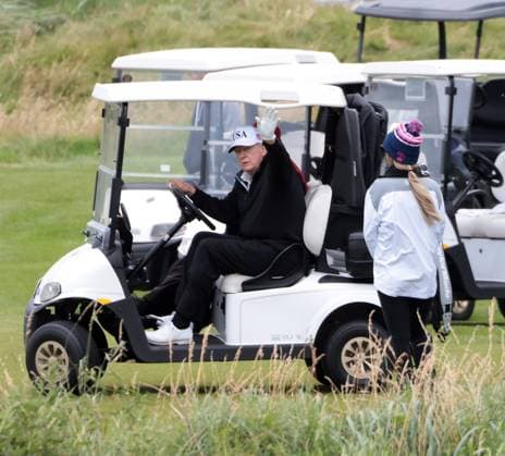 American President Donald Trump waves to the media whilst playing golf at Turnberry Golf Club, Ayrshire in Scotland on Sunday, July 27, 2025. Trump is on a four day visit to Scotland where he will be playing golf and meeting International leaders for trade discussions.  LON2025072712 HUGOxPHILPOTT