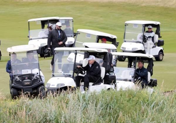 American President Donald Trump drives his golf buggy at Turnberry Golf Club, Ayrshire in Scotland on Sunday, July 27, 2025. Trump is on a four day visit to Scotland where he will be playing golf and meeting International leaders for trade discussions.  LON2025072716 HUGOxPHILPOTT