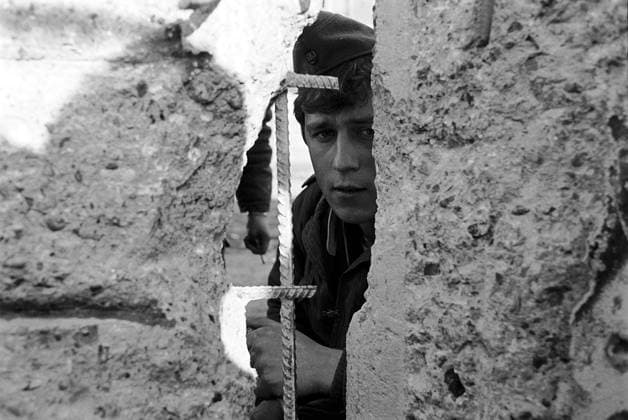 The Fall of the Berlin Wall Nov 20, 1989; Berlin, Germany; East German army peering thru wall, nine days after the Berlin Wall was broken.. Copyright: xCarolinaxSalguerox