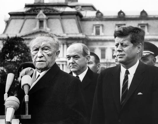U.S. President John F. Kennedy looking on as Chancellor of West Germany, Dr. Konrad Adenauer, delivers remarks during arrival ceremonies in his honor with U.S. Secretary of State, Dean Rusk, standing in center, South Lawn, White House, Washington, D.C., USA, Abbie Rowe, White House Photographs, November 14, 1962  Copyright: xCircaxImagesx ghi-circa13504