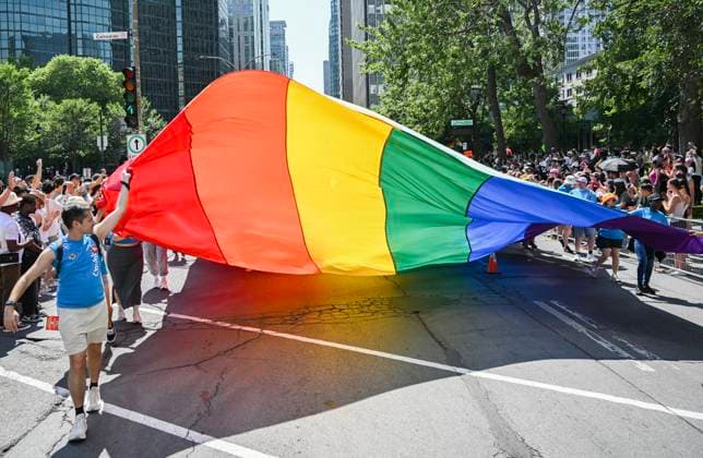 August 10, 2025, Montreal, Pq, Canada: Participants pull a rainbow flag along a street during the Pride parade in Montreal, Sunday, August 10, 2025. Montreal Canada  - ZUMAc35_ 20250810_zaf_c35_008 Copyright: xGrahamxHughesx
