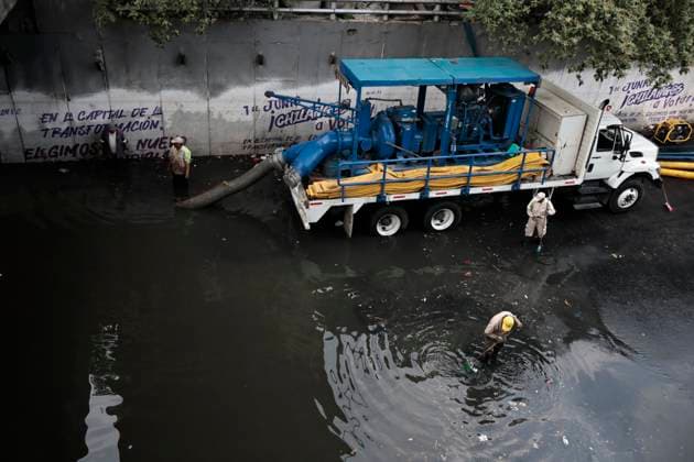 August 11, 2025, Mexico, Cdmx, Mexico: In the Venustiano Carranza region, very close to Mexico City International Airport (AICM), flooding occurred due to recent heavy rains. The vehicles transported to the airport were affected, especially under bridges, where rainwater and sewage from the sewers covered some cars, preventing their owners from getting them out in time. Mexico City sanitation and water workers are working constantly using machinery to remove water from these tunnels and unclog the sewers to remove vehicles that have been totally lost. Mexico Mexico - ZUMAp204 20250811_zip_p204_070 Copyright: xJosuexPerezx