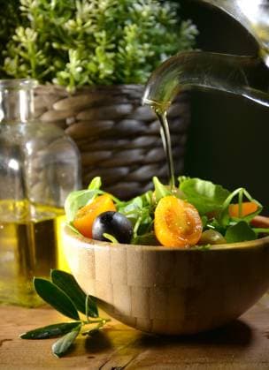 Olive oil falling on two olive with olive leaves to flavor a Mediterranean salad . Typical dish of the Mediterranean diet Model Released LuisMarioHernandez_ID30122_1016690_003 Copyright: xx RECORD DATE NOT STATED