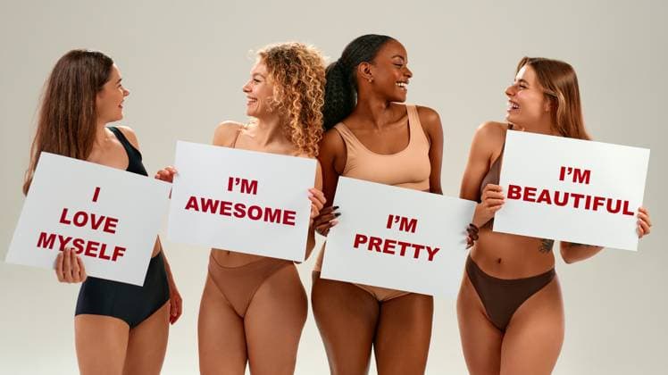 Diverse women holding self-love signs promoting body positivity and confidence Four smiling women of different ethnicities in underwear proudly holding placards with affirmations. Concept of self-love, empowerment, and body acceptance. Model Released OrionProduction_ID30910_1048130_078 Copyright: xx
