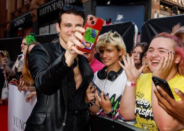 August 12, 2025, London, United Kingdom: YUNGBLUD aka Dominic Richard Harrison poses with a fan at the YUNGBLUD. Are You Ready, Boy? Premiere at the Vue in Leicester Square. London United Kingdom - ZUMAs197 20250812_aaa_s197_433 Copyright: xCatxMorleyx