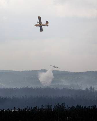 August 14, 2025, St. John s, Nl, CANADA: Water bombers provide a steady steam of water to assist crews on the ground at the Paddy s Pond wildfire, just outside St. John s, N.L., on Thursday, Aug. 14, 2025. St. John s CANADA  - ZUMAc35_ 20250814_zaf_c35_069 Copyright: xPaulxDalyx