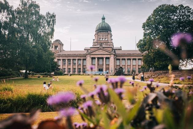Historic courthouse building with dome at Sievekingplatz in Hamburg surrounded by park and people relaxing. *** Historic courthouse building with dome at Sievekingplatz in Hamburg surrounded by park and people relaxing 