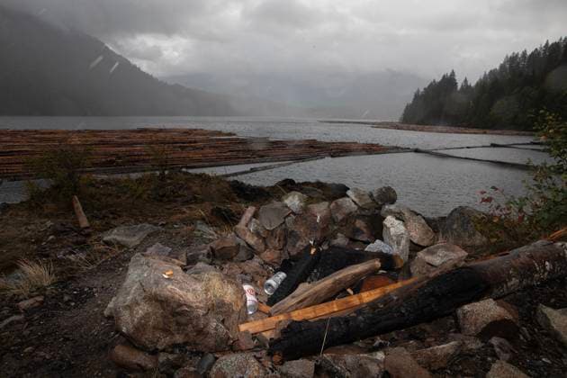 August 16, 2025, Port Alberni, Bc, CAN: Cigarette butts and beer cans from a disgarded campfire on the shore of the Alberni Inlet looking towards Underwood Mountain where a wildfire continues to burn south of Port Alberni, B.C., on Saturday, August 16, 2025. Port Alberni CAN  - ZUMAc35_ 20250816_zaf_c35_129 Copyright: xChadxHipolitox