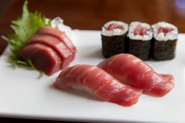 Tuna sashimi and sushi arranged on white plate Chatham, MA, United States R_JUCU210219A-641742-01