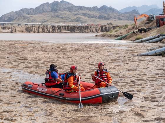 (250818) -- BAYANNUR, Aug. 18, 2025 -- Firefighters search for missing individuals in Urad Rear Banner of Bayannur City, north China s Inner Mongolia Autonomous Region on Aug. 18, 2025. The death toll from a flash flood that swept through a wild camping site in north China s Inner Mongolia Autonomous Region has risen to ten, with two people still missing, local emergency authorities said on Sunday. More than 700 rescuers have been promptly dispatched to the site, urgently searching for the missing. ) (SpotNews)CHINA-INNER MONGOLIA-BAYANNUR-FLASH FLOOD-RESCUE (CN) MaxJinrui 