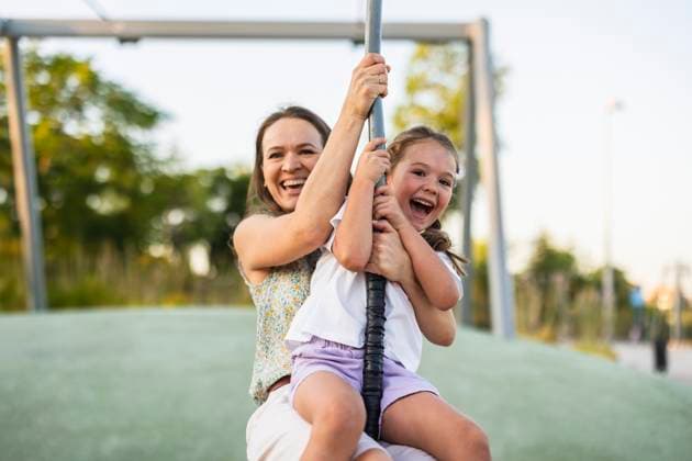 Creative Highlight Symbolbilder Mother and daughter enjoying zipline adventure in park outdoors model released, Symbolfoto, JCCMF14119