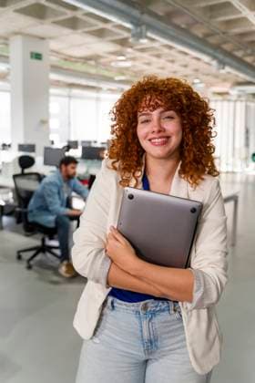 Creative Highlight Symbolbilder Confident professional smiling with laptop in modern office environment model released, Symbolfoto property released, JMHMF00790
