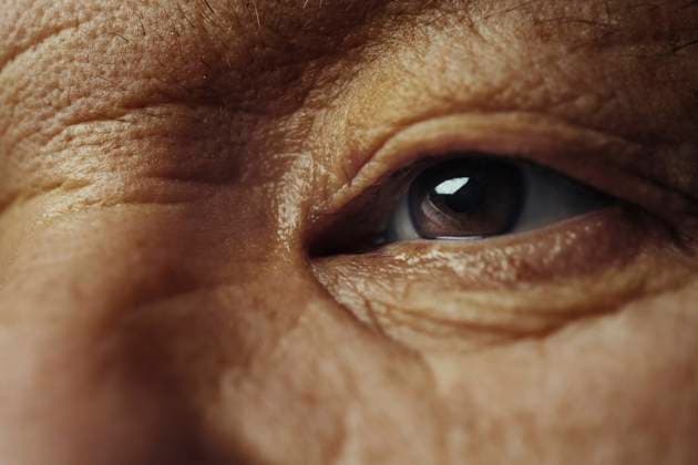 Creative Highlight Symbolbilder Close up of human eye with wrinkles and detailed facial texture model released, Symbolfoto, AZF00754