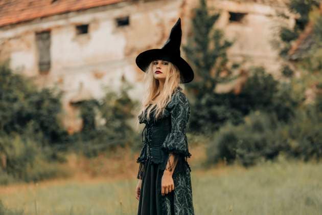 Woman in witch costume outdoors near an old village building on Halloween model released, Symbolfoto, VSNF03845