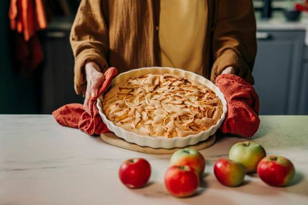 Charlotte pie baking in cozy country kitchen with apples in autumn model released, Symbolfoto property released, VSNF03891