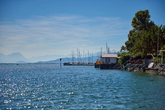 Germany, Lindau island city houses at bodensee lake water panorama view to austrian mountains, alps, pfaender peak and nature landscape. Germany, Lindau island city houses at bodensee lake water panorama view to austrian mountains, alps, pfaender peak and nature landscape., 63143648.jpg RECORD DATE NOT STATED