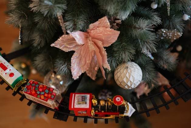 Enjoy a festive Christmas Tree Decor with a charming Train and lovely Ornaments A beautifully decorated and adorned Christmas tree that features colorful ornaments and a charming toy train, 63638982.jpg RECORD DATE NOT STATED