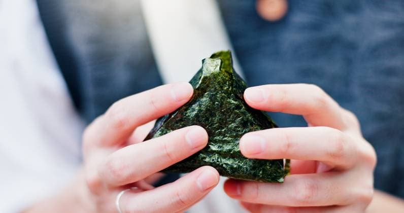 IMAGO Creative, Food, Japan, Onigiri Hands, person and rice ball in Japan for food, traditional snack or fresh natural seaweed triangle for culture. Onigiri, closeup or eating meal for organic lunch, hungry or healthy diet for nutrition Hands, person and rice ball in Japan for food, traditional snack or fresh natural seaweed triangle for culture. Onigiri, closeup or eating meal for organic lunch, hungry or healthy diet for nutrition., model released, , 63250996.jpg RECORD DATE NOT STATED