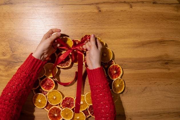 Step 3 DIY process of woman tying ribbon Christmas arrangement with dried oranges and grapefruits. Series of handmade craft instruction. Zero waste eco-friendly winter holiday decoration Step 3 DIY process of woman tying ribbon Christmas arrangement with dried oranges and grapefruits. Series of handmade craft instruction. Zero waste eco-friendly winter holiday decoration. New year, 95589066.jpg RECORD DATE NOT STATED